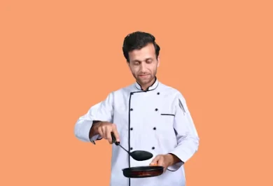 Chef from India holding a pan