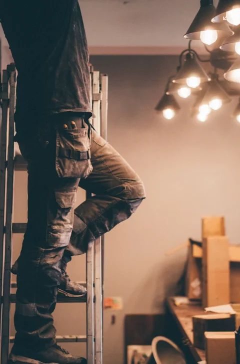 Electrician on a ladder during an installation